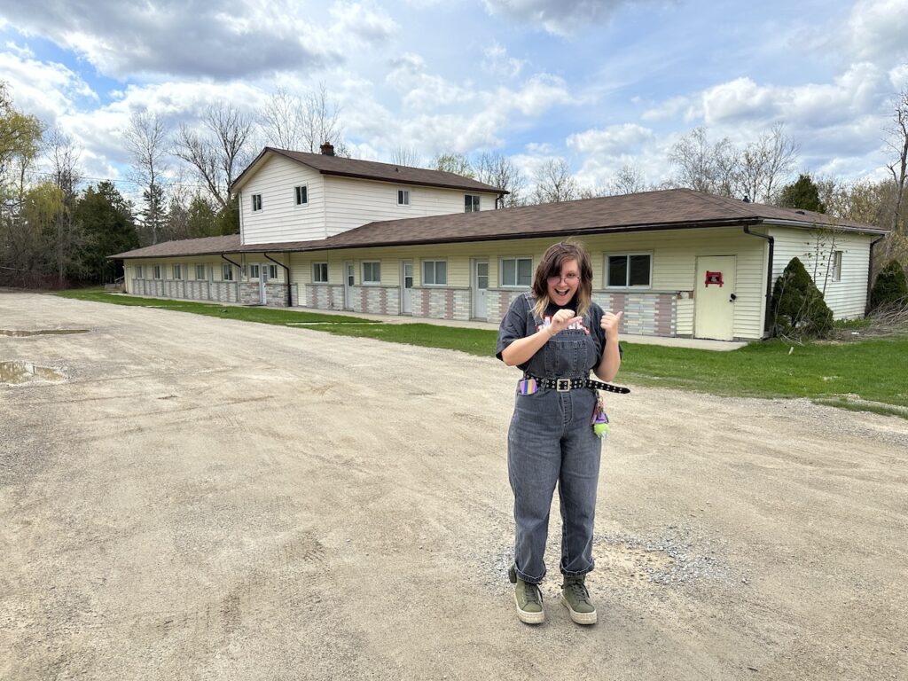 Teen girl in front of Schitt's Creek Motel